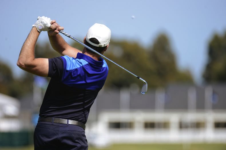 Golfer swinging club
